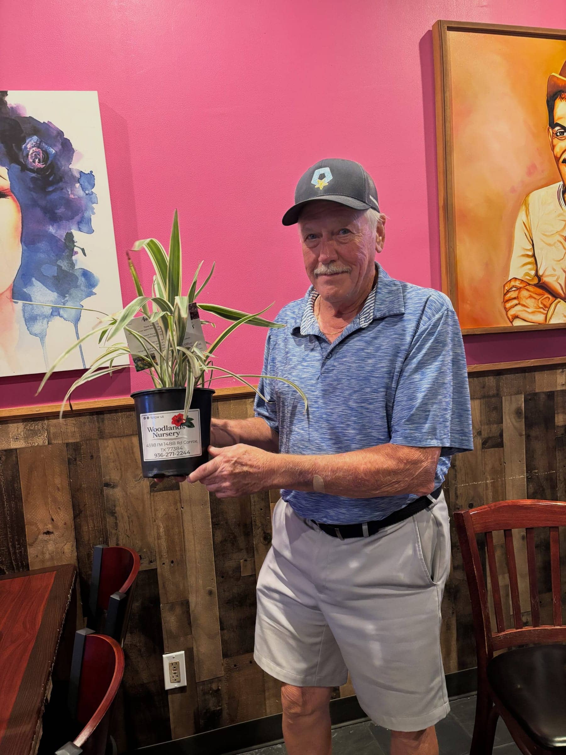 A customer holding a potted variegated plant